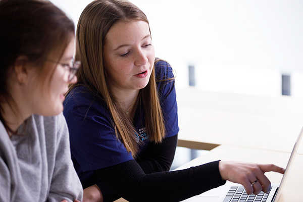 two students on a laptop