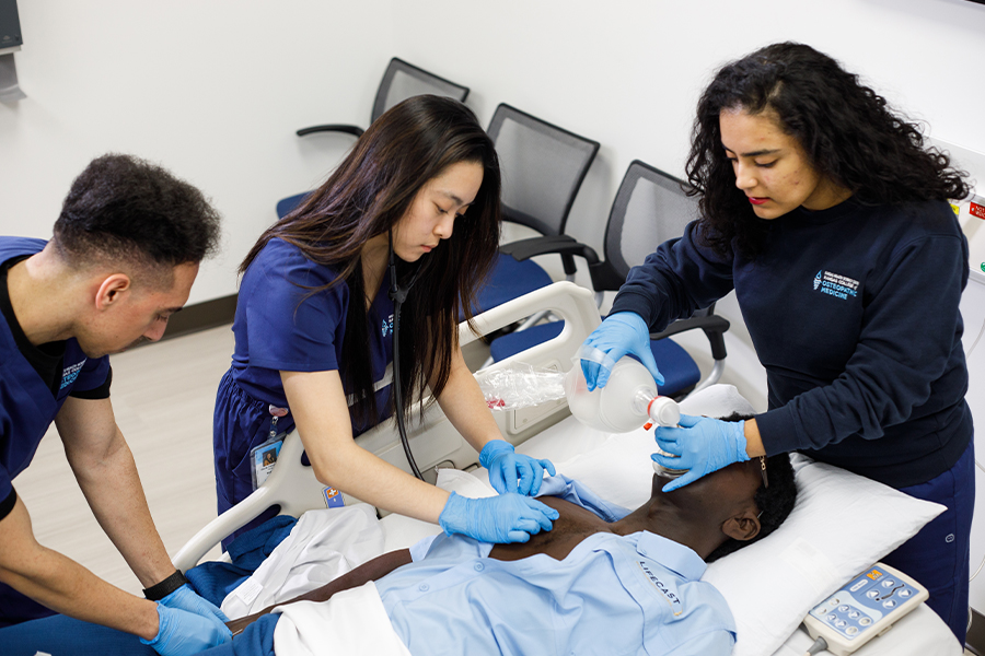 Osteopathic medical students working on patient