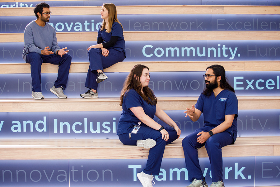 A group of students gathered on the stairs in conversation.