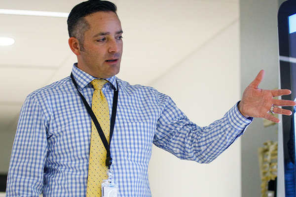 A teacher speaking in front of a class.