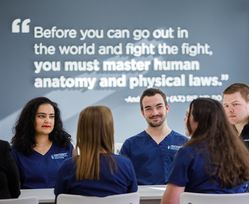 A group of medical students gathering at a table having a conversation